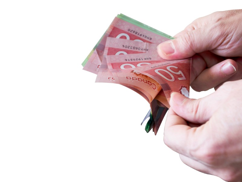 Man Counting Canadian Dollars stock photo