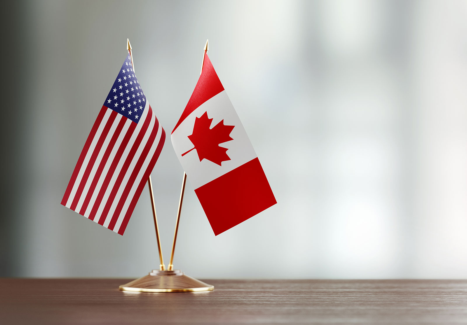 Mini Canadian and US flags on desk, Canada and United States
