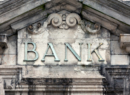 weathered bank sign on building alternate text for this image