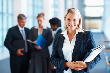 Cute business woman with colleagues in discussion at the background