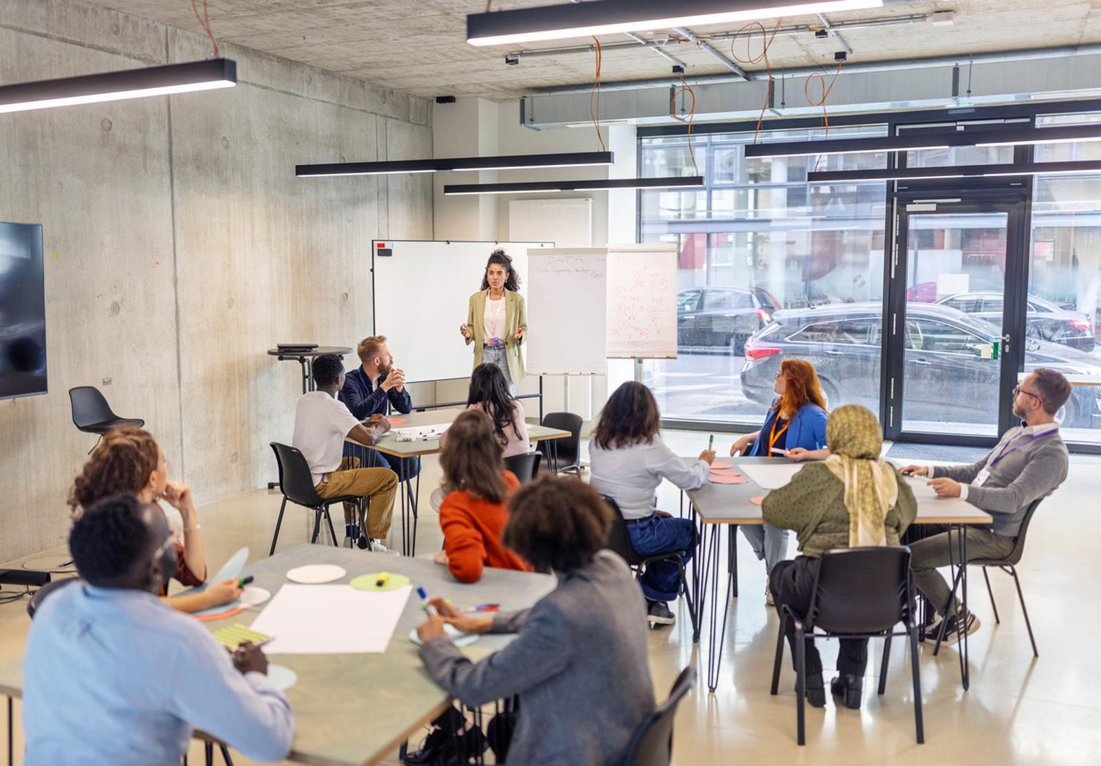Femme d’affaires animant des activités de séminaire avec paperboard lors d’une convention.